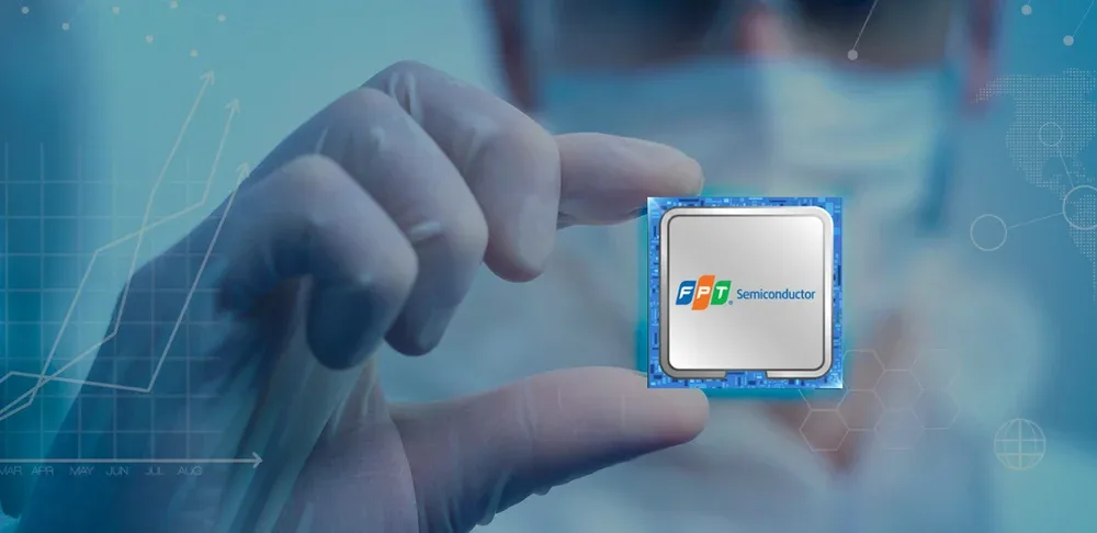 A chip bearing the FPT Semiconductor logo held in a gloved hand